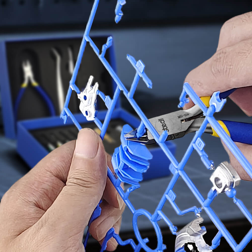 Close-up of stedi MS-104 nippers cutting plastic model parts from a blue sprue runner.